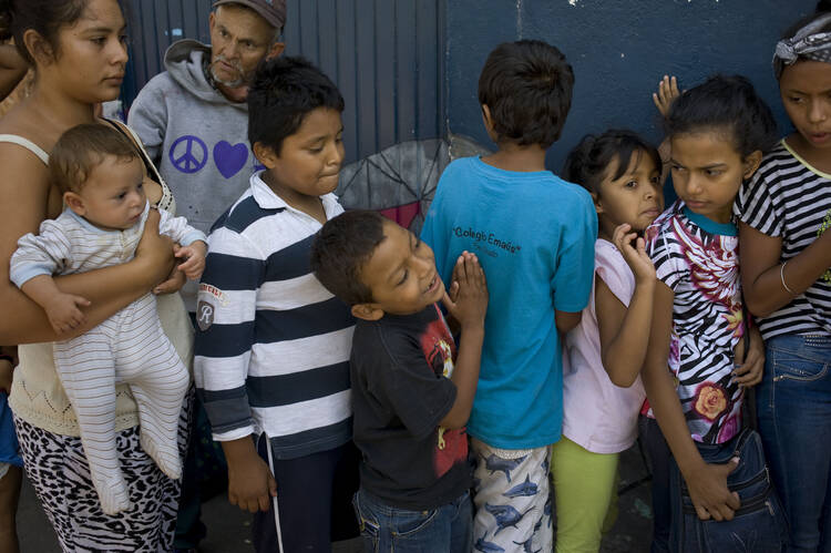 Children wait in line for a meal at the Juventud 2000 migrant shelter in Tijuana, Mexico, April 25. 