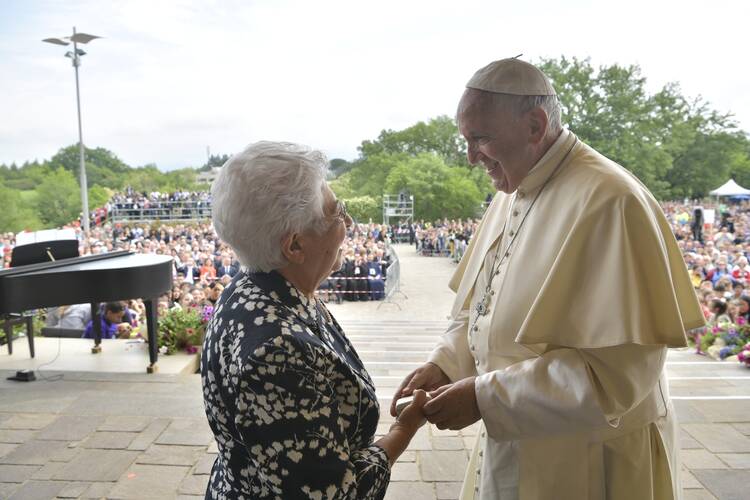 Pope Francis greets a woman in Loppiano, Italy, May 10. (CNS photo/Vatican Media)