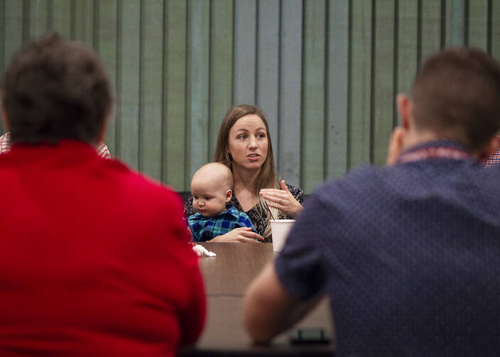Tanelle Pearson is seen with her 7-month-old son during a breakout session on May 16 at the National Young Adult Ministry Summit at the St. John Paul II National Shrine in Washington. (CNS photo/Tyler Orsburn) 