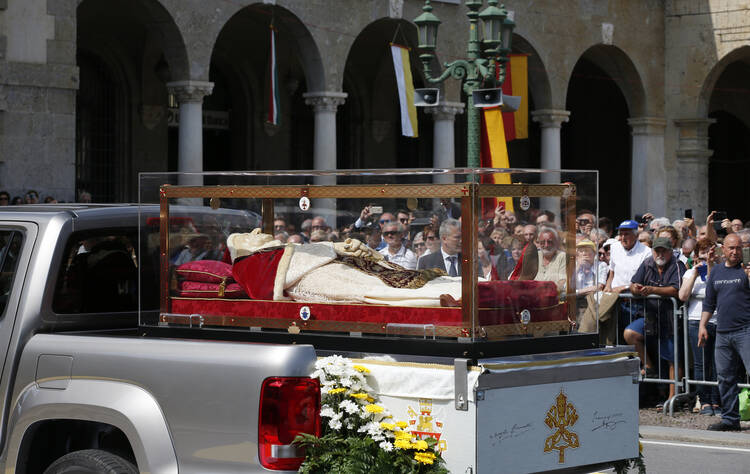 The coffin containing the body of St. John XXIII is seen during a ceremony in Vittorio Veneto Square after its arrival in Bergamo, Italy, May 24. The body of the late pope left the Vatican on May 24 to be displayed in his home region until June 10. (CNS photo/Paul Haring)
