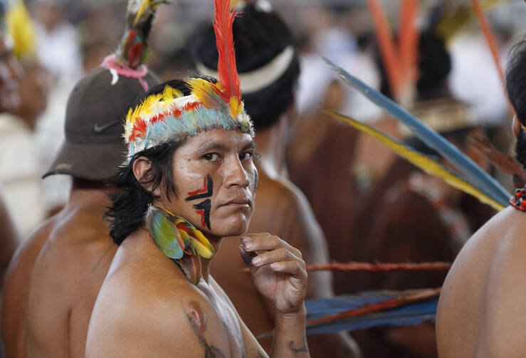 An indigenous community members attends Pope Francis' meeting with people of the Amazon in Puerto Maldonado, Peru, on Jan. 19. A Synod of Bishops on the Amazon region in 2019 will address pastoral needs of a region with few priests for the number of Catholics. (CNS photo/Paul Haring)