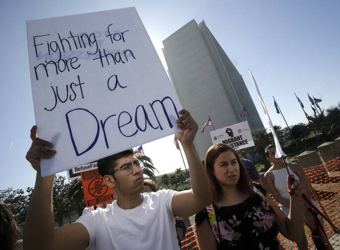 A protester holds a sign that reads "Fighting for more than just a Dream," as he joined Dreamers and hundreds of demonstrators calling for Deferred Action for Childhood Arrivals, or DACA, in early February outside the Federal Building in Los Angeles. (CNS photo/Mike Nelson, EPA
