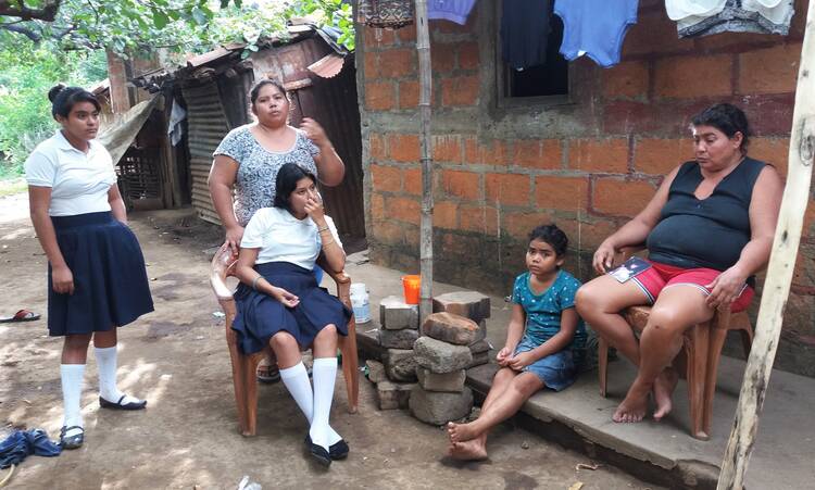 The mother, sister and nieces of Junior Rojas sit outside their home on Aug. 2 in Sutiaba, Nicaragua. On July 5, the Nicaraguan police, with masked and armed paramilitary support, attacked Sutiaba, killing three people, including Rojas. (CNS photo/Steve Lewis)