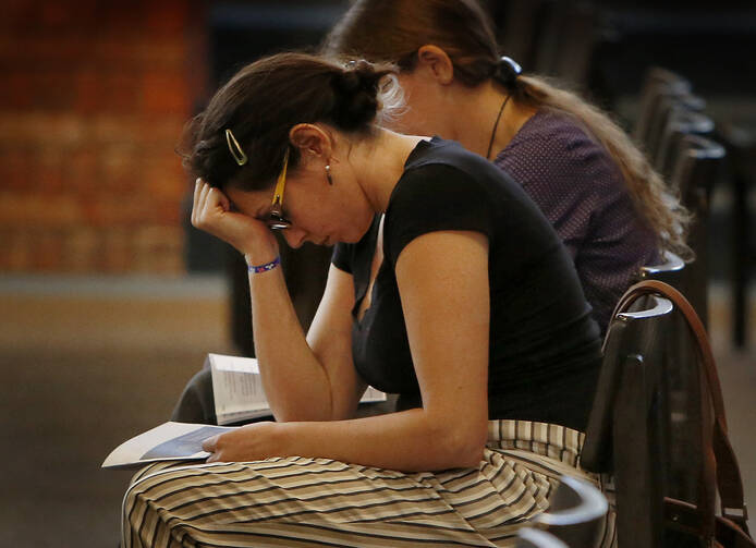 Mariana Hernandez prays during a prayer service for repentance and healing for clergy sexual abuse which included prayers for victims, abusers and the church, Aug. 22 at Our Lady of the Brook in Northbrook, Ill. (CNS photo/Karen Callaway, Chicago Catholic)
