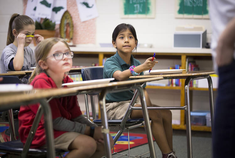 Second-grader Yoselyn Arroyo answers a question in class at Holy Name of Jesus Catholic School in Henderson, Ky. (CNS photo/Tyler Orsburn) 