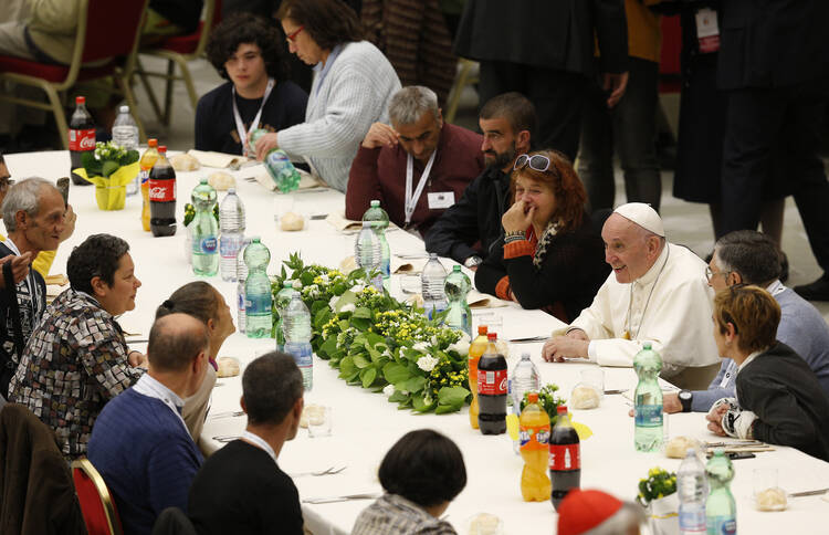 Pope Francis eats lunch with poor people