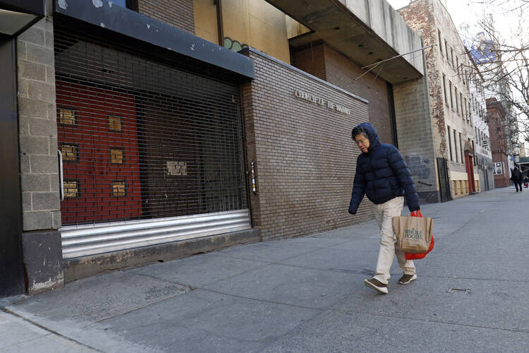 A man walks past the former Church of the Nativity in New York City in December 2018. It was deconsecrated in 2017. (CNS photo/Gregory A. Shemitz) 