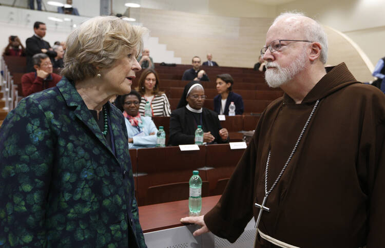 Sheila Hollins, a member of the Pontifical Commission for the Protection of Minors, talks with U.S. Cardinal Sean P. O'Malley, president of the commission, at a 2017 seminar in Rome on safeguarding children. (CNS photo/Paul Haring)