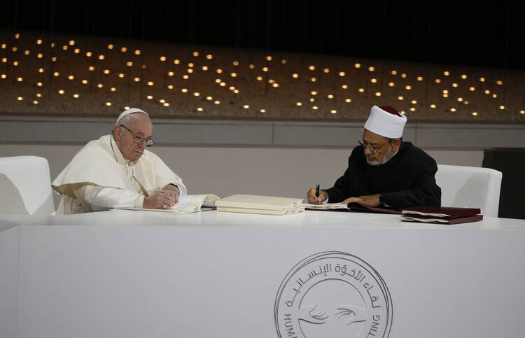 Pope Francis and Sheik Ahmad el-Tayeb, grand imam of Egypt's al-Azhar mosque and university, sign documents during an interreligious meeting at the Founder's Memorial in Abu Dhabi, United Arab Emirates, on Feb. 4, 2019. (CNS photo/Paul Haring) 
