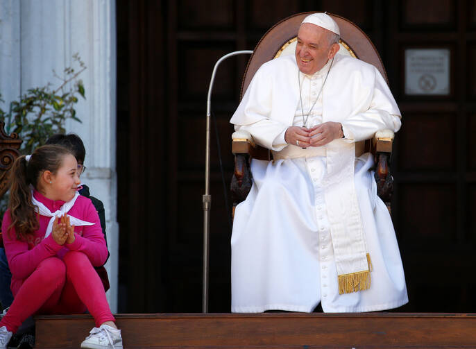 A teenager looks on as Pope Francis smiles during his visit to the Sanctuary of the Holy House on the feast of the Annunciation in Loreto, Italy, March 25. (CNS photo/Yara Nardi, Reuters) 