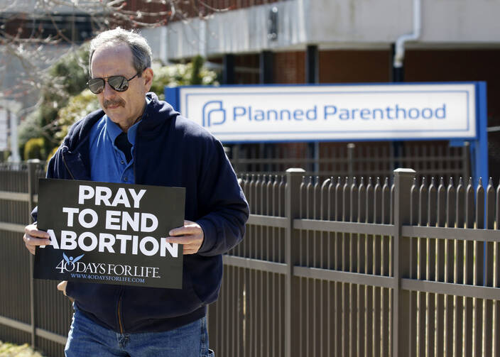Pro-life advocate Joe San Pietro participates in a 40 Days for Life vigil near the entrance to a Planned Parenthood center in Smithtown, N.Y., on March 26. (CNS photo/Gregory A. Shemitz)