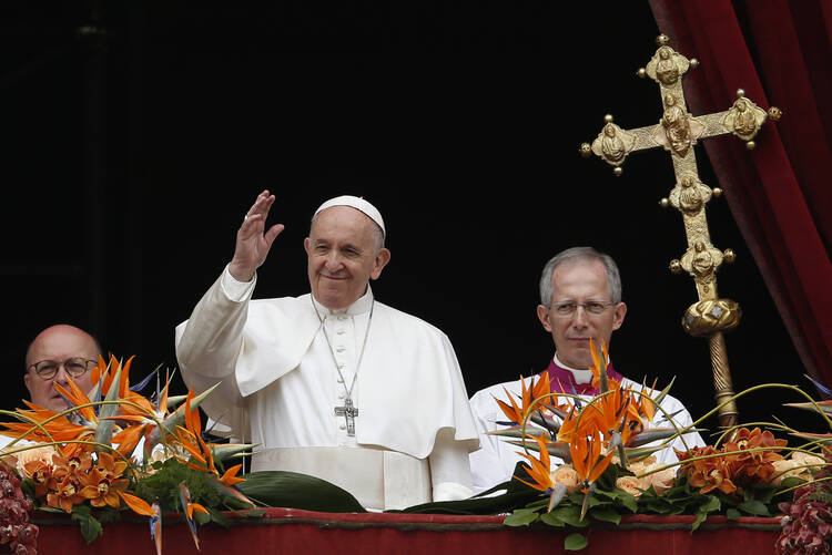 Pope Francis greets the crowd after delivering his Easter message and blessing "urbi et orbi" (to the city and the world) from the central balcony of St. Peter's Basilica at the Vatican April 21, 2019. (CNS photo/Paul Haring)