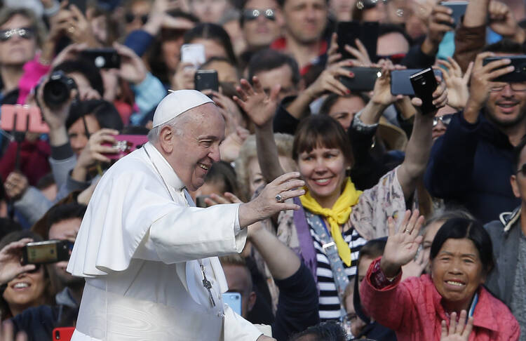 Pope Francis greets the crowd during his general audience in St. Peter’s Square at the Vatican on May 1. (CNS photo/Paul Haring)