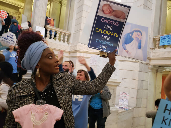 Elizabeth Koroma protests in the Rhode Island Statehouse on May 14 against state legislation aimed at expanding legal abortion. (CNS photo/Brian Fraga, Rhode Island Catholic)