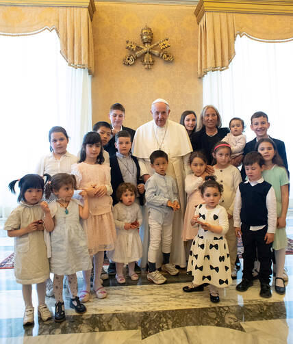 Pope Francis poses during an audience with a delegation from the Institute of the Innocents, a Florence-based organization dedicated to caring for children. The pope met the delegation at the Vatican May 24, 2019, during an audience marking the 600th anniversary of the Italian institute. (CNS photo/Vatican Media)