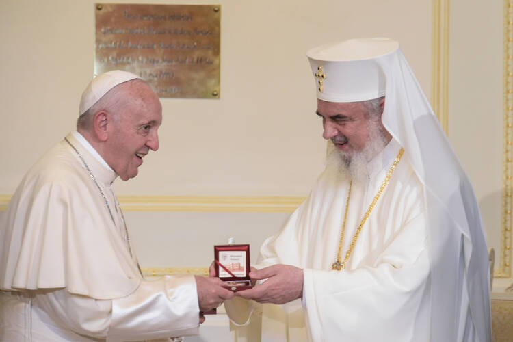 Pope Francis and Romanian Orthodox Patriarch Daniel exchange gifts at the patriarchal palace in Bucharest, Romania, May 31, 2019. The pope is making a three-day visit to Romania. (CNS photo/Vatican Media) 