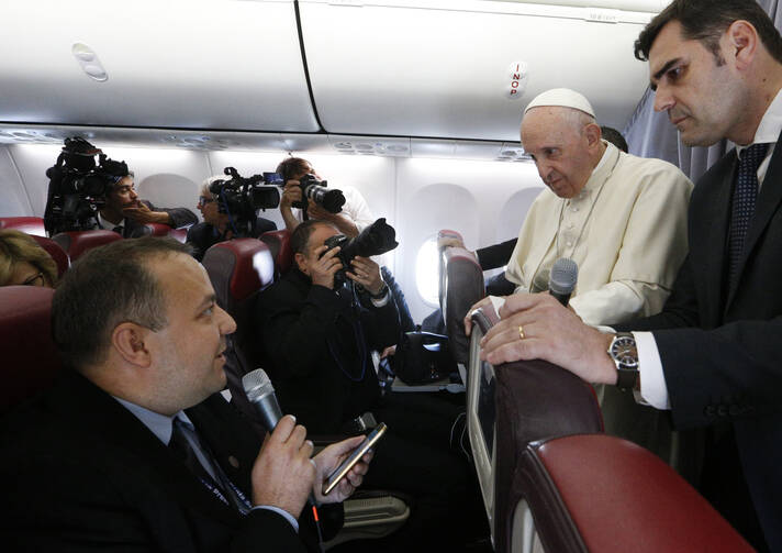 Pope Francis listens to a question from Romanian journalist Cristian Micaci aboard his flight from Sibiu, Romania, to Rome June 2, 2019. (CNS photo/Paul Haring) 