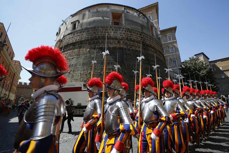 Recruits of the Vatican's Swiss Guard march in front of the tower of the Institute for Works of Religion in 2014. (CNS photo/Tony Gentile, Reuters)