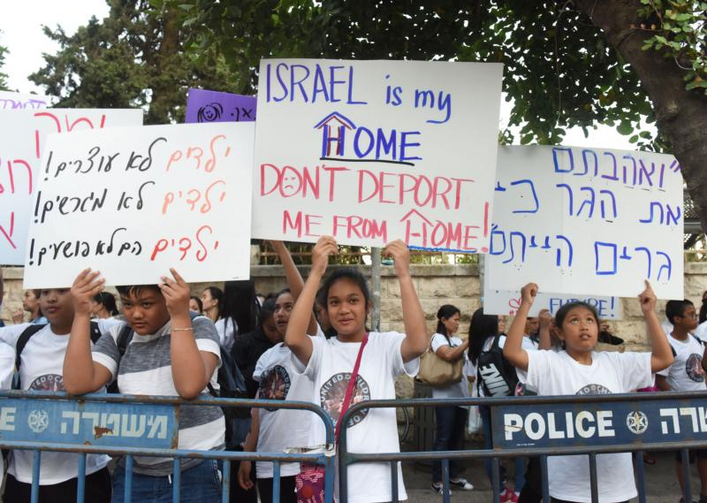 Image: Filipino children demonstrate June 12, 2019, near Israeli Prime Minister Benjamin Netanyahu's house in Jerusalem. Their signs, in English and Hebrew, say they do not want to be deported. Most of their mothers arrived legally in Israel to work as caretakers for the elderly, but then remained in the country after their work visas had expired and have lived in Israel for up to 20 or more years. (CNS photo/Debbie Hill)