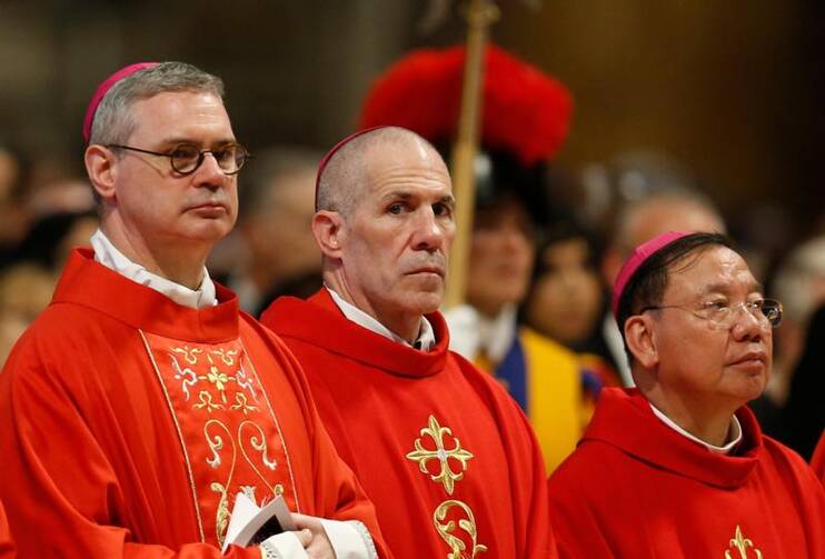 Archbishops Peter A. Comensoli of Melbourne, Australia, Michael Byrnes of Agana, Guam, and Joseph Vu Van Thien of Ha Noi, Vietnam, attend Pope Francis' celebration of Mass marking the feast of Sts. Peter and Paul in St. Peter's Basilica at the Vatican June 29, 2019.