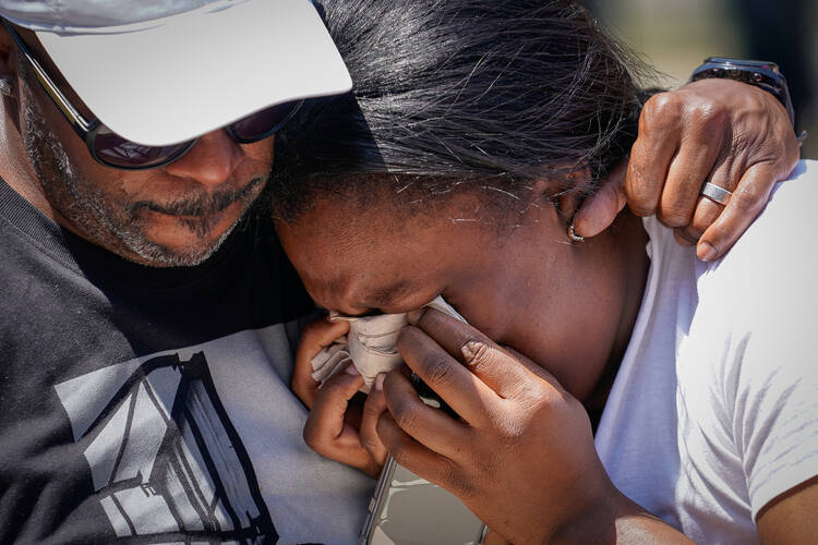 A woman becomes emotional during a vigil in Dayton, Ohio, Aug. 4, 2019. Pope Francis joined Catholic Church leaders expressing sorrow after back-to-back mass shootings in the United States left at least 29 dead and dozens injured in Texas and Ohio Aug. 3 and 4. (CNS photo/Bryan Woolston, Reuters) 