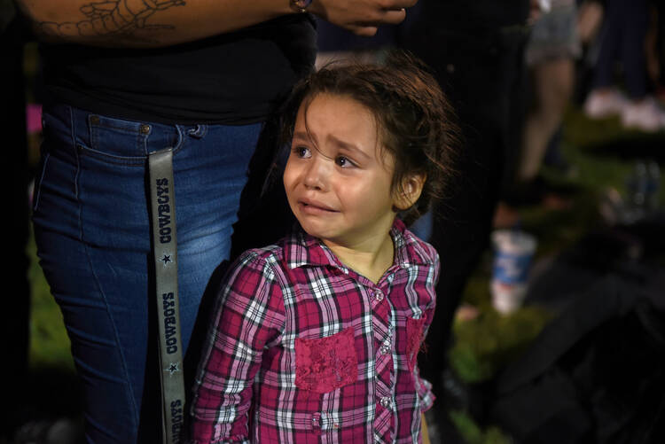  Serenity Lara cries during an Aug, 4, 2019, vigil, a day after a mass shooting at a Walmart store in El Paso, Texas. Pope Francis joined Catholic Church leaders expressing sorrow after back-to-back mass shootings in the United States left at least 31 dead and dozens injured in Texas and Ohio Aug. 3 and 4. (CNS photo/Callaghan O'Hare, Reuters) 