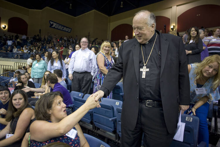 San Diego Bishop Robert W. McElroy greets an attendee during an Aug. 13, 2019, meeting with all of the more than 2,500 San Diego diocesan employees in response to Pope Francis' call to confront sexual abuse of minors and other vulnerable people. (CNS photo/David Maung) 