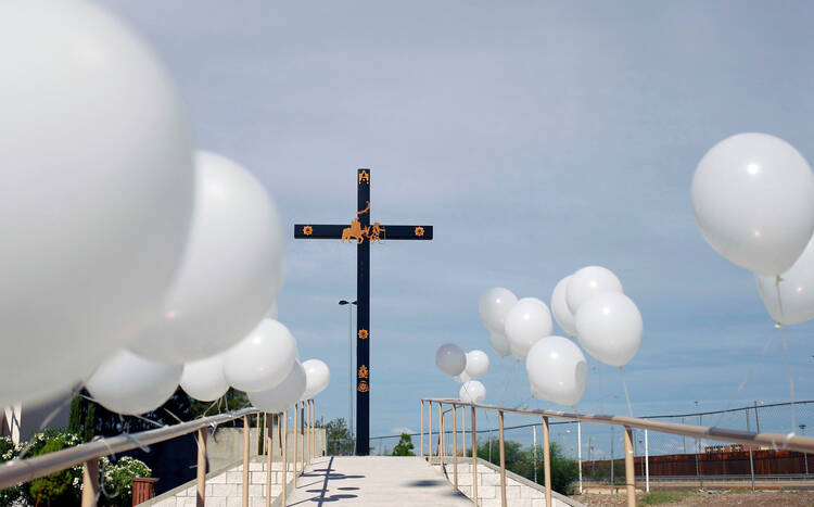 An altar is adorned with white balloons at a "Mass for the Peace" Aug. 10, 2019, in Ciudad Juarez, Mexico, one week after a mass shooting at a Walmart store in nearby El Paso, Texas. (CNS photo/Jose Luis Gonzalez, Reuters) 