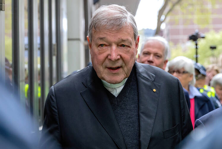 Australian Cardinal George Pell is surrounded by police as he leaves the Melbourne Magistrates Court in Australia, October 2017. (CNS photo//Mark Dadswell, Reuters)