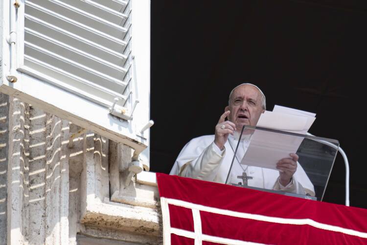 Pope Francis greets the crowd as he leads the Angelus from the window of his studio overlooking St. Peter's Square at the Vatican Aug. 25, 2019. (CNS photo/Vatican Media)