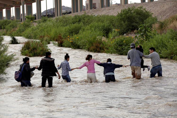 Migrants from Central America seeking asylum in the United States cross the Rio Grande near Ciudad Juarez, Mexico, on June 11. (CNS photo/Jose Luis Gonzalez, Reuters)