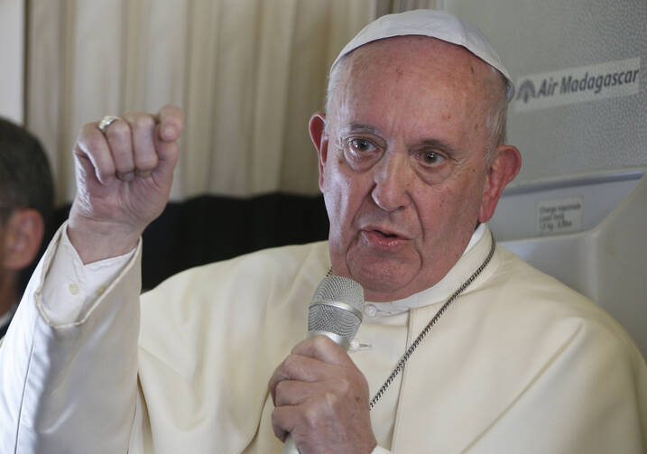 Pope Francis answers questions from journalists aboard his flight from Antananarivo, Madagascar, to Rome on Sept. 10. (CNS photo/Paul Haring)