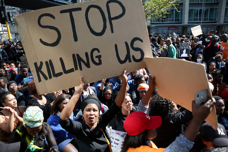 A woman holds a sign as demonstrators gather in September 2019, at the World Economic Forum on Africa in Cape Town during a protest against gender-based violence. (CNS photo/Sumaya Hisham, Reuters) 