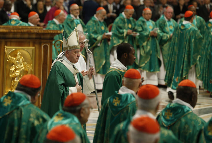 Pope Francis arrives in procession to celebrate the opening Mass of the Synod of Bishops for the Amazon in St. Peter's Basilica at the Vatican on Oct. 6. (CNS photo/Paul Haring)