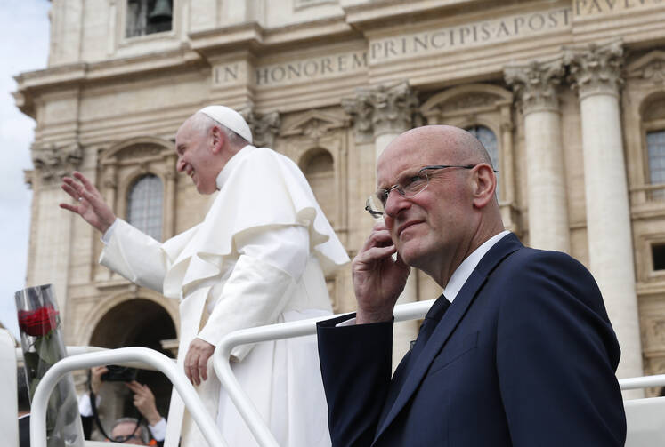 Domenico Giani, lead bodyguard for Pope Francis and head of the Vatican police force, keeps watch as the pope leaves his general audience in St. Peter's Square at the Vatican May 1, 2019. Pope Francis accepted the resignation of Giani Oct. 14, nearly two weeks after an internal security notice was leaked to the Italian press. (CNS photo/Paul Haring)
