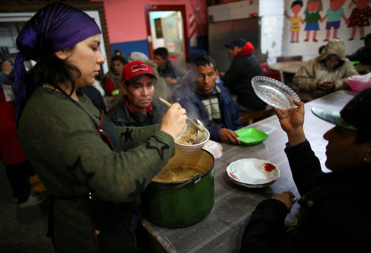 A volunteer serves a meal at a soup kitchen in Buenos Aires, Argentina, Oct. 4, 2019. Resolving the global crises of world hunger and malnutrition demands a shift away from a distorted approach to food and toward healthier lifestyles and just economic practices, Pope Francis said in an Oct. 16 message. (CNS photo/Agustin Marcarian, Reuters) 