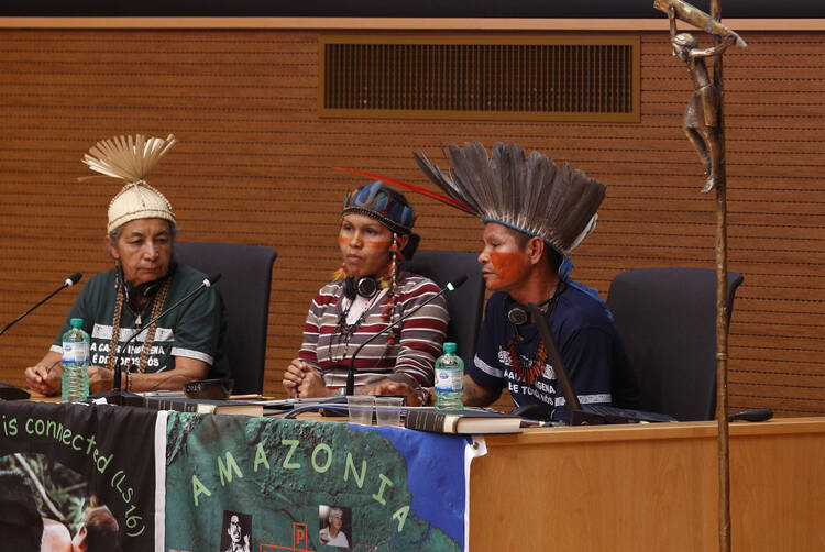 Francisco Chagas Chafre de Souza, a leader of the Apurina in Brazil's Amazon region, speaks at a meeting of indigenous people from North America and South America at the Jesuit General Curia in Rome Oct. 17, 2019. Also pictured are Dona Zenilda with the Xucuru people of northeast Brazil, and Ednamar de Oliveira Viana, a leader of the Satere-Mawe people in Brazil. The meeting was a side event to the Synod of Bishops for the Amazon. (CNS photo/Paul Haring)