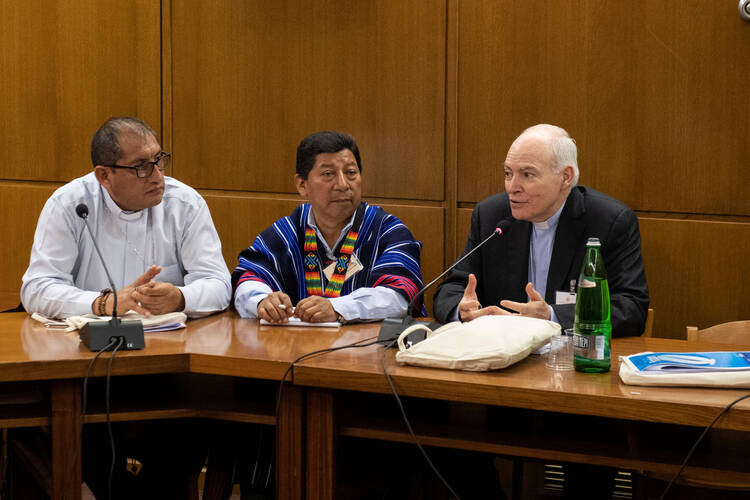 Cardinal Carlos Aguiar Retes of Mexico City, right, speaks to members of a small working group at the Synod of Bishops for the Amazon on Oct. 10, 2019, in the Vatican synod hall. (CNS photo/Vatican Media)