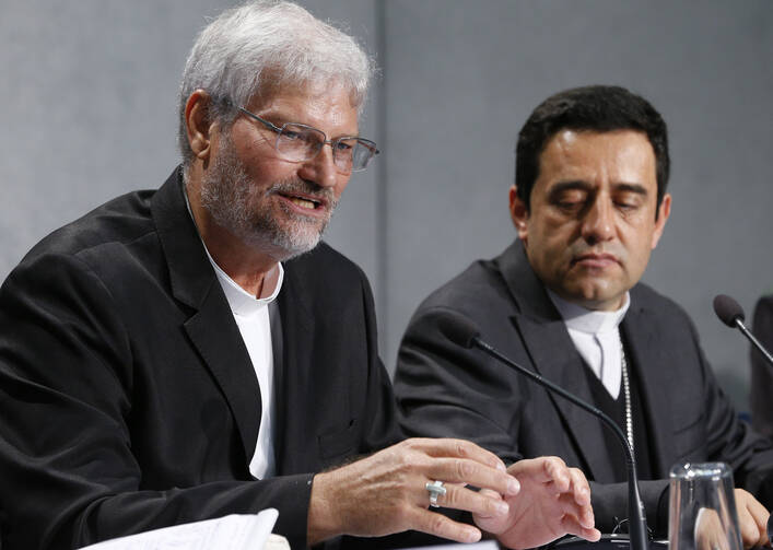Bishop Evaristo Pascoal Spengler of Marajo, Brazil, speaks during a news conference after a session of the Synod of Bishops for the Amazon at the Vatican Oct. 25, 2019. Also pictured is Bishop Joaquin Pinzon Guiza of PuertoLeguizamo, Colombia. (CNS photo/Paul Haring) 
