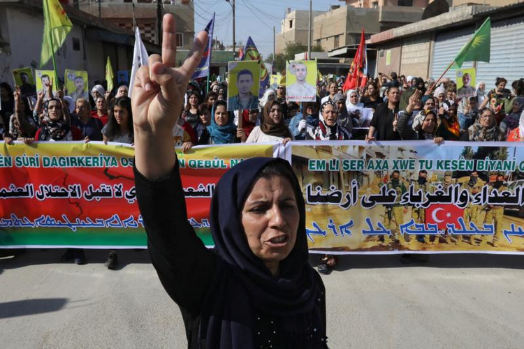 Image: Kurdish and Arab protesters chant slogans against Turkish President Recep Tayyip Erdogan as they walk during a march to U.N. headquarters in Qamishli, Syria, Oct. 23, 2019. (CNS photo/Muhammad Hamed Reuters)