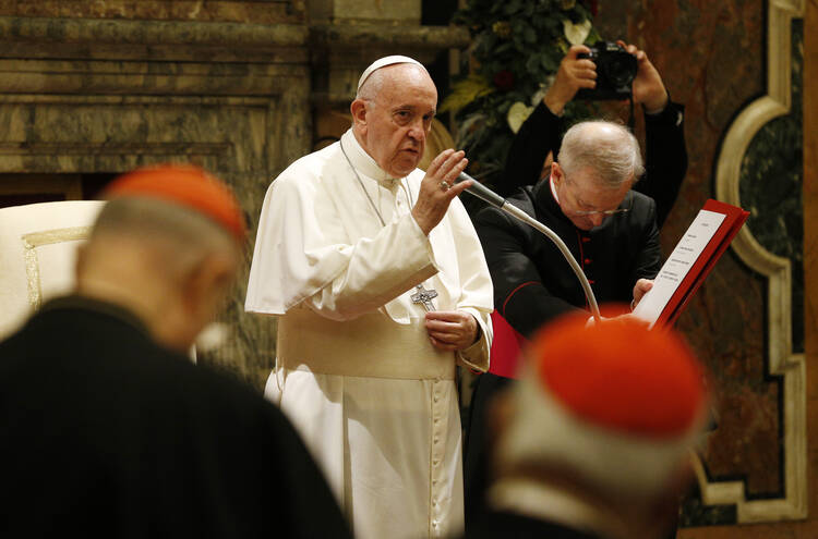 Pope Francis delivers his blessing during his annual audience to give Christmas greetings to members of the Roman Curia at the Vatican on Dec. 21. (CNS photo/Paul Haring) 