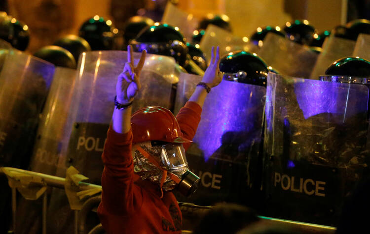 An anti-government protester in Beirut demonstrates in front of riot police Dec. 15, 2019. (CNS photo/Mohamed Azakir, Reuters) 