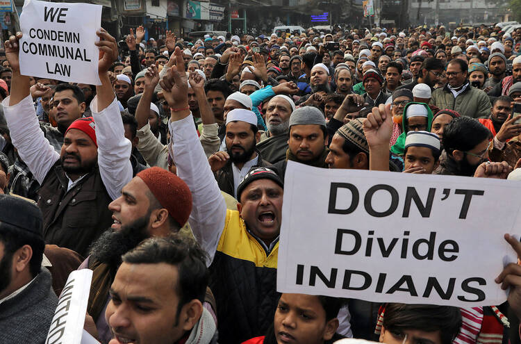 Demonstrators in Delhi, India, protest a new citizenship law on Dec. 27, 2019. Opponents say new law targets Muslim refugees, unlike people of other faiths. (CNS photo/Anushree Fadnavis, Reuters)