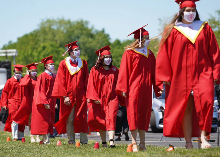 Graduating seniors line up to receive their diplomas after exiting their vehicles during a drive-in commencement on June 14, 2020, at St. John the Baptist Diocesan High School in West Islip, N.Y. (CNS photo/Gregory A. Shemitz)