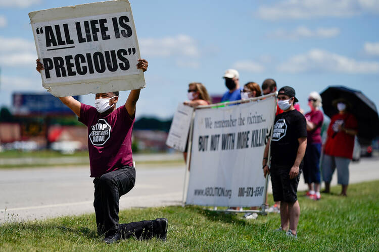 Demonstrators are seen near the Federal Correctional Complex in Terre Haute, Ind., to show their opposition to the death penalty July 13, 2020. (CNS photo/Bryan Woolston, Reuters)