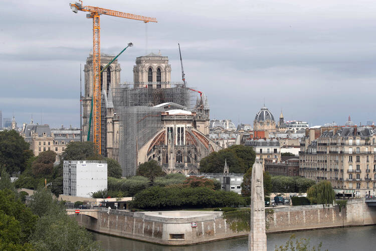 Workers remove scaffolding from the remains of the roof of the damaged Notre Dame Cathedral in Paris July 14, 2020, after the historic cathedral was partially destroyed in a 2019 fire. A new study has found that the amount of lead that settled to the ground and likely seeped into houses downwind of the fire was far greater than officials indicated at the time. (CNS photo/Charles Platiau, Reuters) 