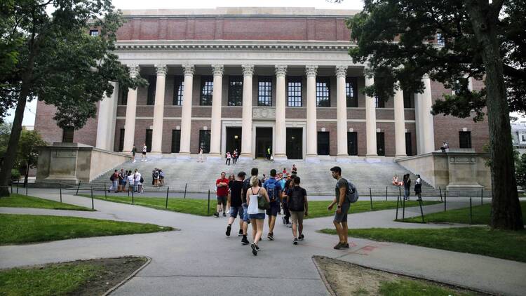 Harvard University, which will require most of its undergraduates to take classes remotely this fall, joined a lawsuit against a directive that would have rescinded visas from international students unable to attend classes in person. (AP Photo/Charles Krupa, File)