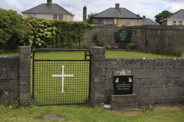 This June 4, 2014 file photo shows the site of a mass grave for children who died in the Tuam mother and baby home, in Tuam, County Galway, Ireland. The Vatican has indicated its support for a campaign to exhume the bodies of hundreds of babies who were buried on the grounds of a Catholic-run Irish home for unwed mothers to give them a proper Christian burial. (Niall Carson/PA via AP, file)