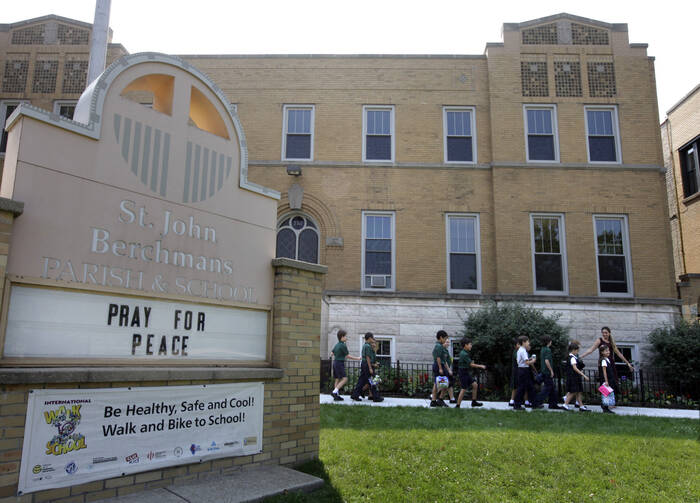 Third graders at St. John Berchmans School in Chicago walk outside of the building, in this 2013 file photo. Catholic schools, especially those serving urban areas, have been disproportionately impacted in the ongoing fallout of the coronavirus pandemic, three U.S. bishops told the Congressional Black Caucus leaders July 31, 2020. (CNS photo/Karen Callaway, Catholic New World) 