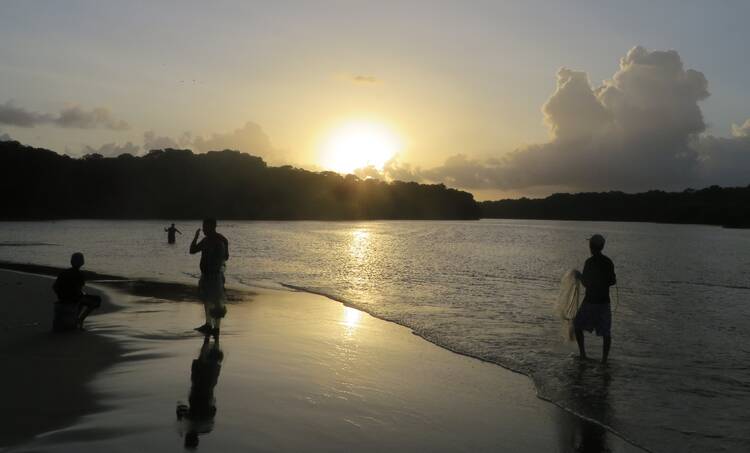 Fishermen at sunset in November 2015 along the freshwater lagoon in Tela, Honduras. (CNS photo) 